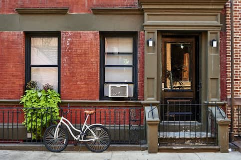 a bike in front of a brownstone building