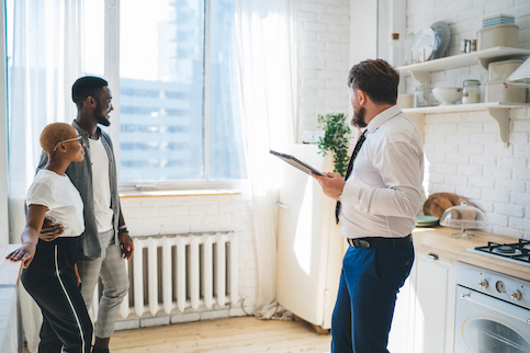 Agent showing young couple an apartment.