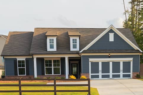 Ash Blue House With Brown Roof With Fence