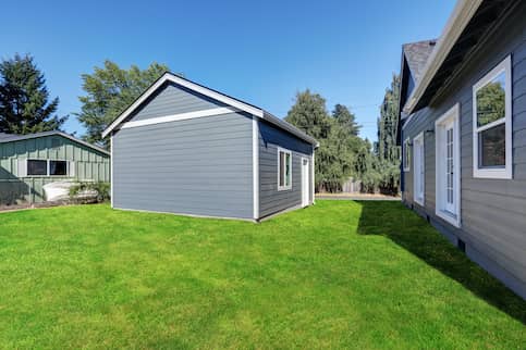 Blue House With Blue Detached Shed