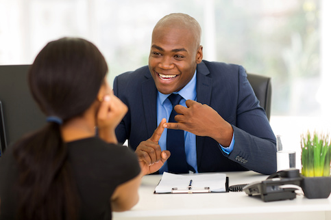 Businessman laughing with client in office