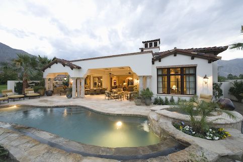 white house with an in-ground pool and hot tub