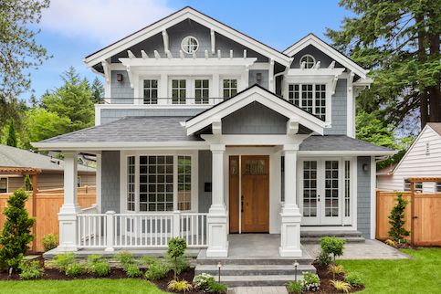 front of modern gray house with pergolas over windows