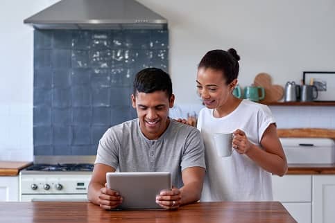Couple looking at computer in Kitchen