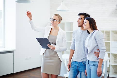 Couple Looking At Property With Realtor