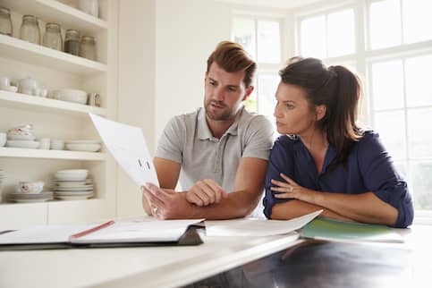 couple looking at finances in home