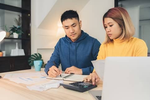 Couple reviewing finances at kitchen table