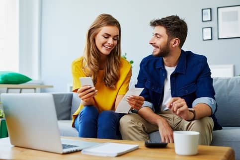 couple with laptop looking at finances