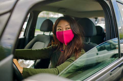 Woman conducting a drive by appraisal in car.