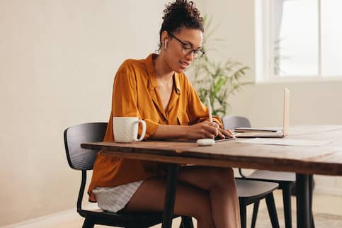 Woman reviewing escalation clause for her offer on her dream home. 