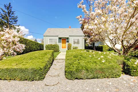 Small Home With Blooming Spring Trees