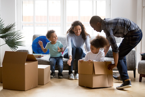 Family in new home unpacking boxes