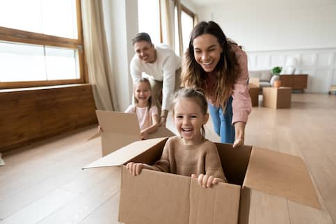 family packing and playing in boxes