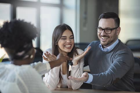 First Time Home Buyer Couple Excited To Get Keys From Realtor 