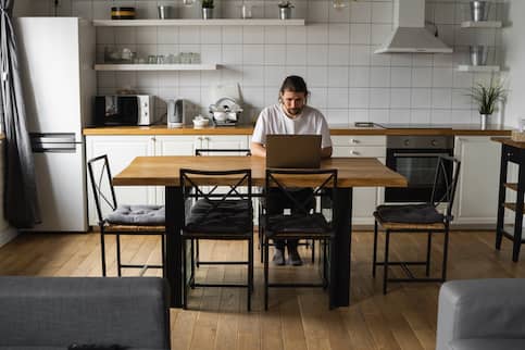 Freelancer working from kitchen table. 