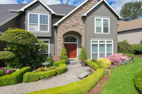 Grey Suburban House with Summer Landscaping 