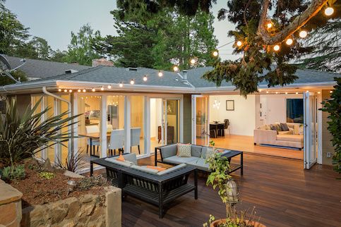 Large patio with couches and string lights. 