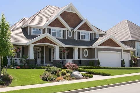 house with green grass and small white porch