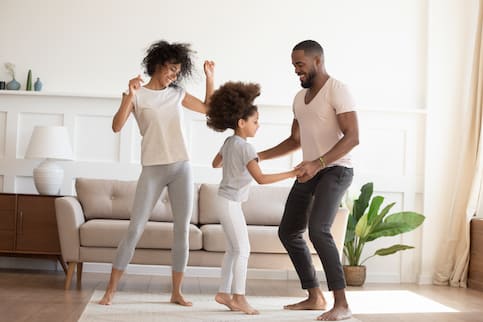 Happy Family Dancing In Living Room
