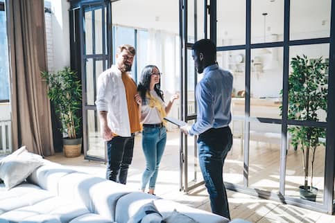 Couple looking at investment property with Realtor
