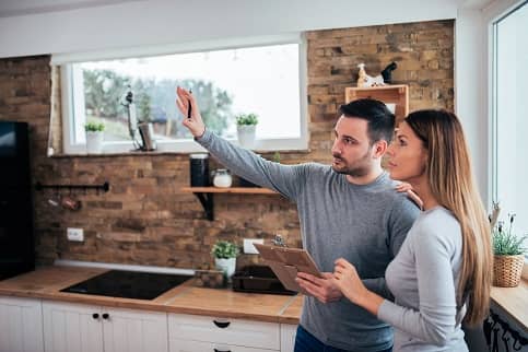 Couple in kitchen planning home renovations