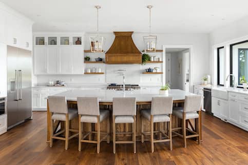 Kitchen with hardwood floors and white cabinets.