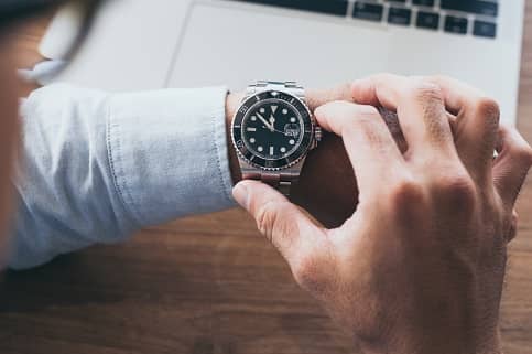 Man looking at watch on wrist