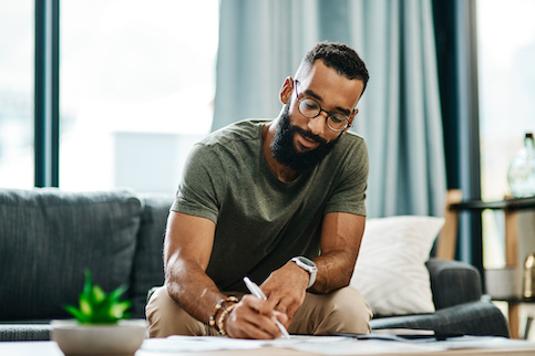 Man paying bills at coffee table