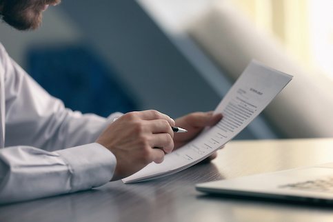 Man reading through a contract he's going to sign.