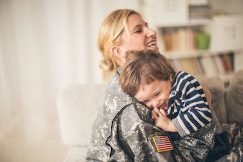Military mom hugging son. 
