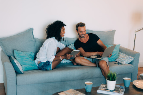 Couple sitting on couch in new home. 