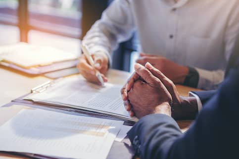 people sitting down and going over a contract