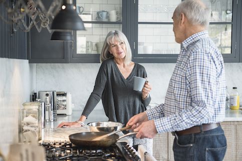 Older couple in kitchen together. 