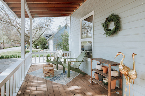 Porch with chairs and decor.