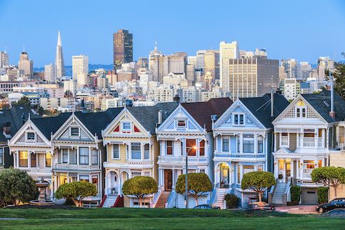 Homes very close to each other with the skyline of San Francisco in the background.