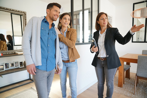 Realtor showing a cis couple an entertainment room in a home