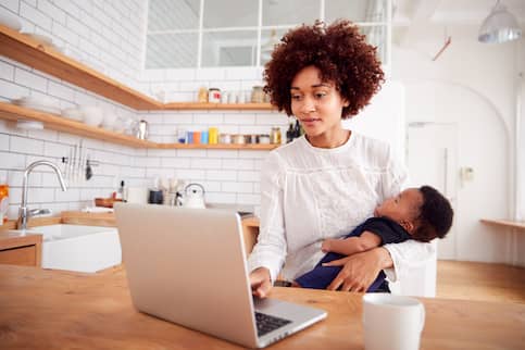 Woman with infant preparing to refinance her home loan. 