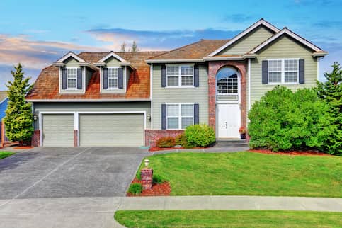 Sage Green Home With Red Roof And Brick Archway