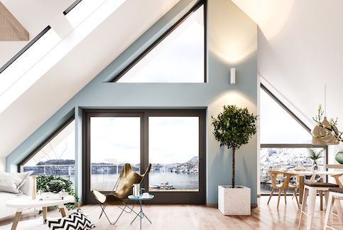 Scandinavian interior loft with large windows and sparse furniture. 