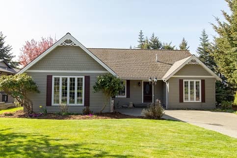 Brown Ranch Style Home With White Trimming