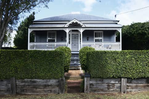 small house with hedges