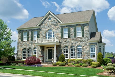 stone wall two-story house