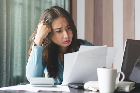 Stressed woman struggling with bills.