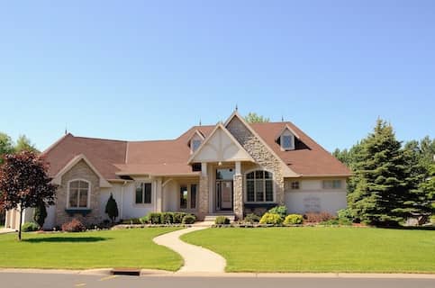 tan house exterior with winding front yard path