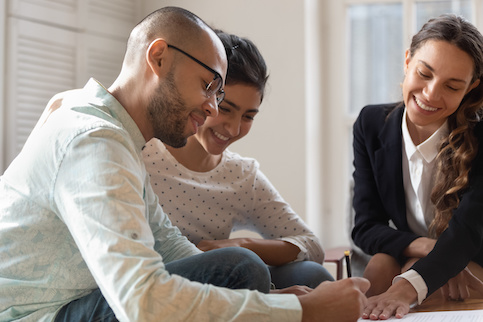 Couple meeting with Realtor to go over mortgage terms.