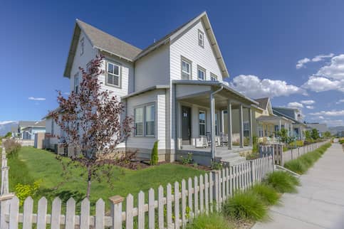 White Suburban Home With Brushed Grey Fence