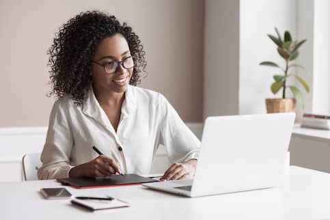 Young woman using laptop computer at office.