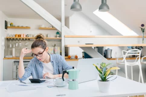 Woman Paying Bills Online At Home