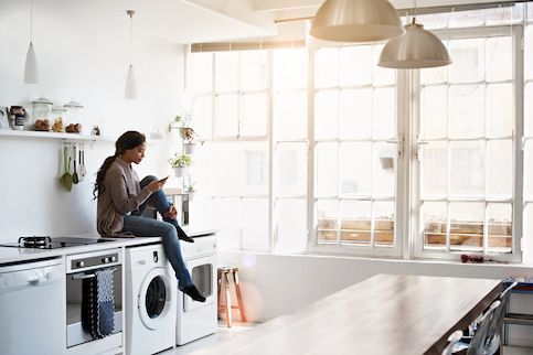 Woman sitting on kitchen counter.