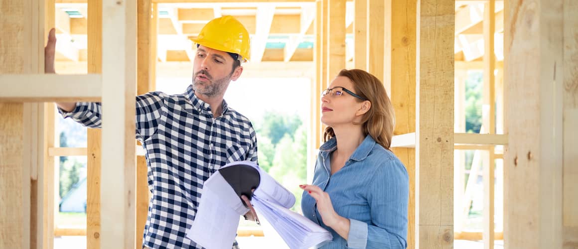 Woman With Contractor Building House